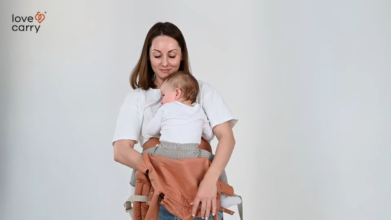 Love & Carry® Primo Baby Carrier. How to take your baby out of the back carry position